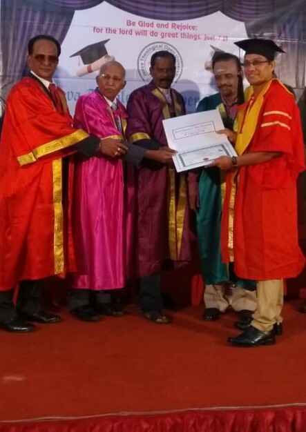 Receiving a doctorate certificate on stage at a PhD award ceremony