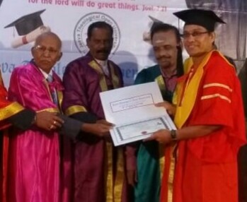 Receiving a certificate from the university dignitaries at a PhD award ceremony