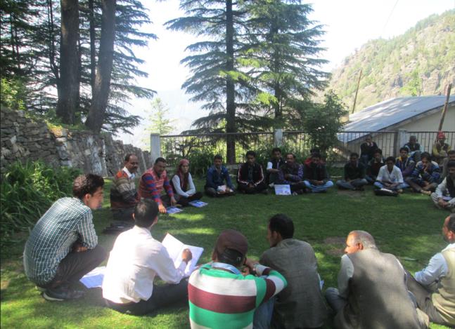Farmers learning in a circle on a lawn